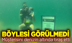 Müşterisini denizin altında tıraş etti